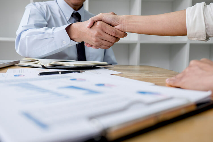 Two business people shaking hands on a deal