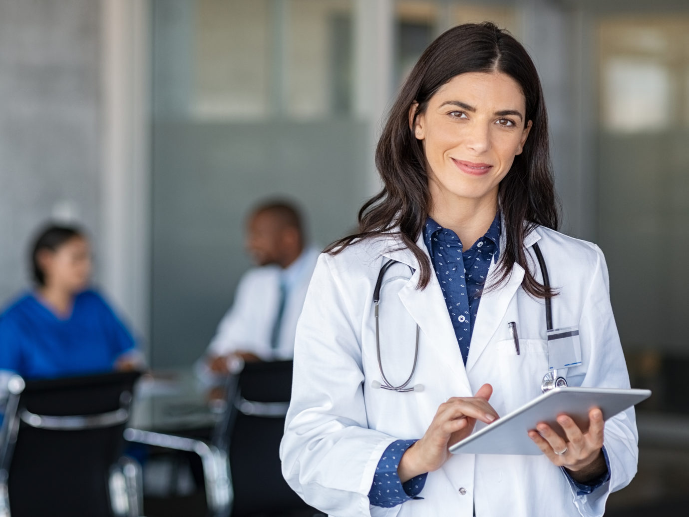 Doctor holding digital tablet at meeting room