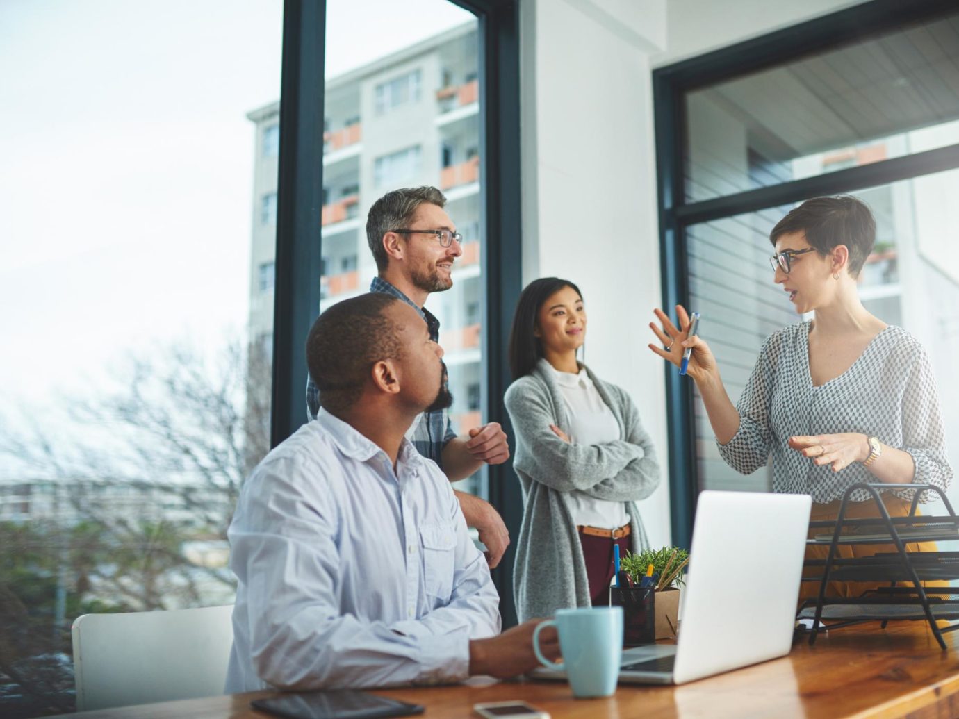 A group of colleagues having a discussion in a modern office