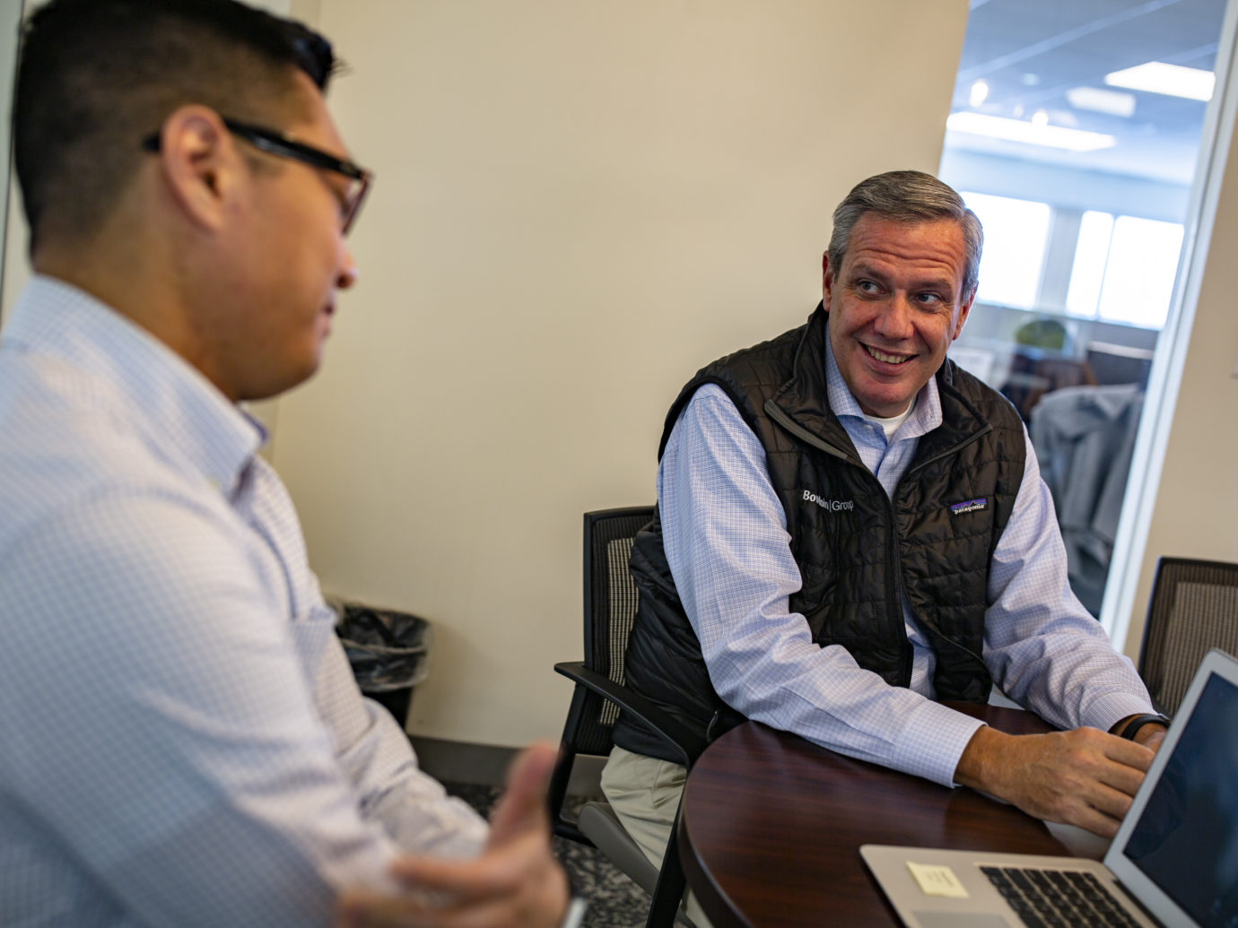 Two Bowdoin team members in a conference room